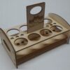 A wooden holder with a cup and a bottle.