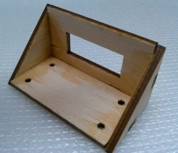 A small wooden shelf with a hole in it.