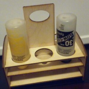 A wooden bottle holder with two bottles in it.