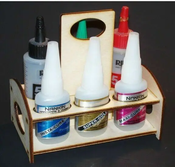 A wooden holder with several bottles of glue.