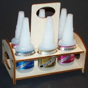 A wooden holder with five bottles of glue in it.