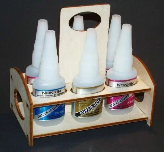 A wooden holder with five bottles of glue in it.